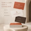 Orange, cream, and brown premium business cards for a boutique hotel displayed above a stacked set