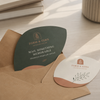 Leaf-shaped business cards displayed with kraft envelopes for promotional mailing