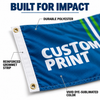 Close-up of a blue polyester flag banner showing a reinforced white grommet strip, stitched edge, and dye-sublimated print.