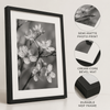 Black-and-white floral photo print with cream-core beveled matting and a black MDF frame
