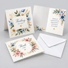 Custom folded greeting cards with blue, white, and pink floral designs, shown open and closed beside a white envelope.