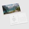 Front and back of a Northline Journeys postcard featuring a mountain lake photograph, message area, address lines, and postage box.