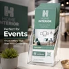 Stack of promotional RIP Cards displayed in a clear holder at an indoor event or trade-show booth.