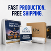 Packaged real estate and construction display boards with four corner grommets beside protective wrap, a Link Printers box, and a UPS truck.