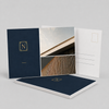 Premium navy-and-gold architectural postcards displayed with coordinated front and mailing-side designs.