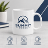 Custom white 11 oz ceramic mug with navy Summit Works logo, durable construction, and C-shaped handle