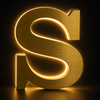Illuminated rear halo lighting on brushed gold metal letters at night