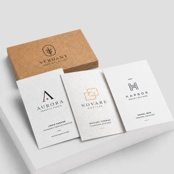 Textured ultra-premium business cards in Kraft and white finishes with black, gold, and navy logo designs