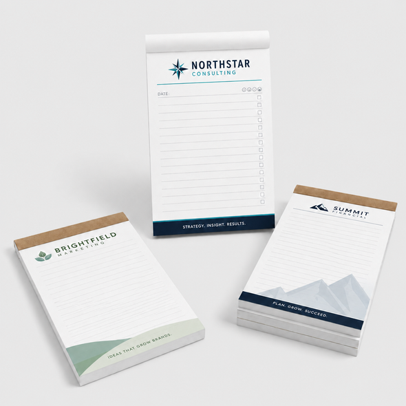 Three custom branded notepads for consulting, marketing, and financial businesses displayed on a clean white background.