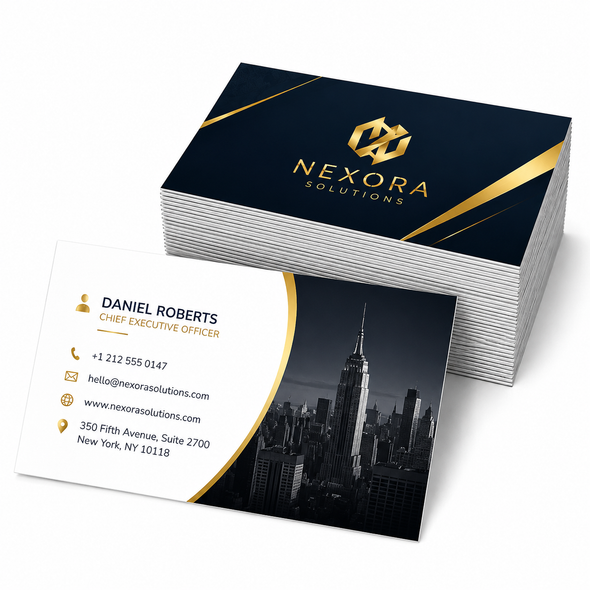 Stack of glossy business cards with navy and gold branding beside a card featuring contact details and a New York skyline