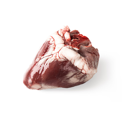 Raw lamb heart on a cutting board, ready to be prepared for cooking. Raw lamb heart on a cutting board, ready to be prepared for cooking.