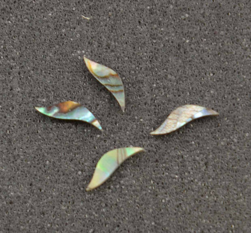 Paua abalone inlay leafs size 3mm (0.118") width x 9mm (0.354") length x 1.5mm (0.06") thickness. Some uses include fretboard markers, musical instrument inlay, furniture inlay, marquetry, pool cue inlay and other general decorative inlay and jewellery applications. Made from laminated Paua shell.