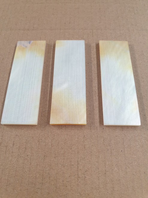 White Mother of Pearl flat inlay blanks size 22mm (0.9") width x 67mm (2.73") length x 2.5mm (0.10") thickness B grade clean on both sides, has some gold/shell skin on ends of one face of blank, other side pure white.