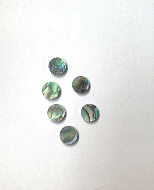 Paua shell dots 10.15mm diameter x 2mm thickness are round flat shell pcs cut to precise diameter and thickness. Ideal for use in inlay applications - for fretboard markers and general inlay or jewellery decorations. All dots are A grade.<br />
