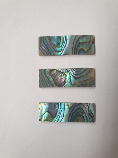 Paua abalone (New Zealand Paua shell) flat inlay blanks size 12mm (0.47") width x 35mm (1.38") length x 2mm (0.08") thickness A grade good on at least 1 side may have some worm damage or shell skin on edges of reverse side.