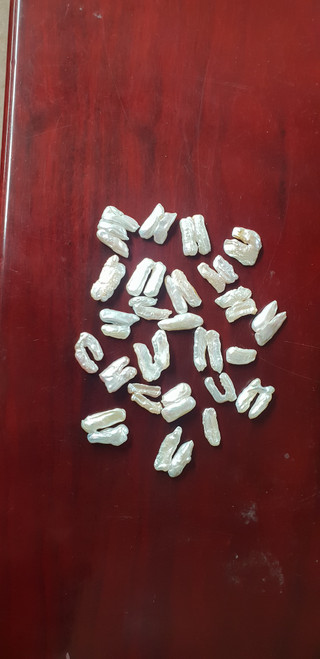 Fresh water random shaped pearls size vary from approx. 20 - 25mm long X 5 - 10mm wide x 3 - 6mm thick. Genuine fresh water mollusk pearls.