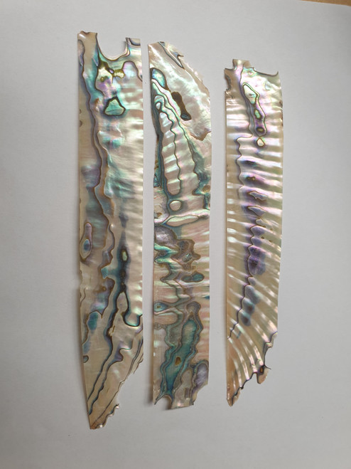 Green abalone shell feathers 25mm (0.984") width x 100-120mm (3.937-4.724") length x 0.5mm (0.02") thickness - thinly sliced solid shell pcs. Cut along the curved part of shell then flattened, they can yield larger pcs then standard solid shell blanks. Ideal for shallow inlay, overlay, fishing lure manufacture and other decorative purposes. Select quality A grade.