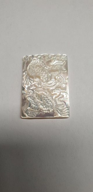 White MOP cabochon dragon 24.5mm width  x 34.5mm length x 4mm thickness. Best grade W, MOP carving high quality precision work. Suitable for jewellery and other decorative applications. A grade.