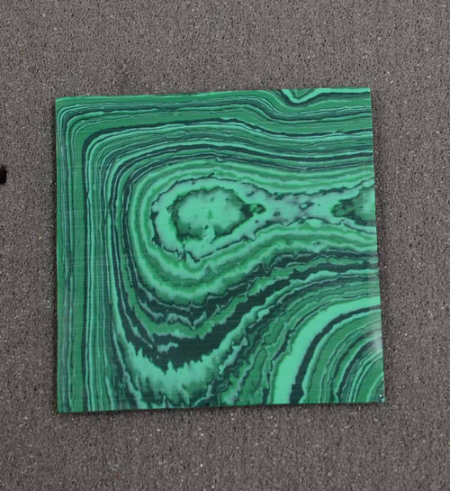 Malachite C025 artificial stone blanks polished 1 side 50x50x2.5mm suitable for inlay. Can be cut with standard cutting tools - jewellery saw similar in characteristics to mother of pearl (hardness approx. 3. Can be sanded and polished same way as shell material. All pcs are A grade good on both sides.