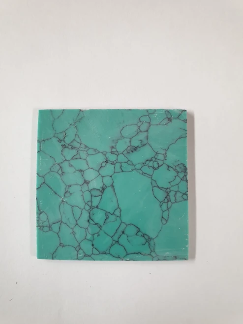 Turquoise Green M114 artificial stone blanks 50 x 50 x 1.5mm polished 1 side. Suitable for inlay. Can be cut with standard cutting tools - jewellery saw similar in characteristics to mother of pearl (hardness approx. 3. Can be sanded and polished same way as shell material. All pcs are A grade good on both sides.