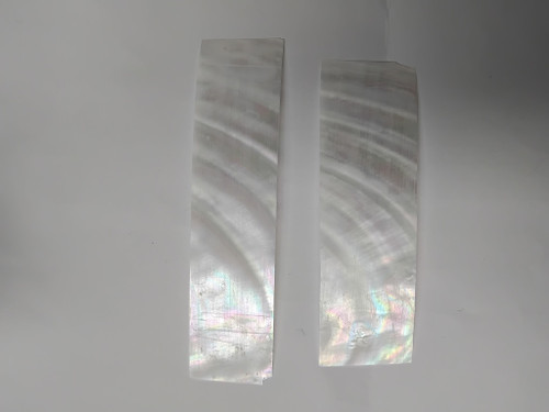 Fresh water pearl feathers white colour feathers 30mm width x 80mm to 120mm length x 0.15mm (0.006") thickness - thinly sliced solid shell pcs. Cut along the curved part of shell they can yield larger pcs then standard solid shell blanks. Ideal for shallow inlay, overlay, fishing lure manufacture and other decorative purposes. Select quality A grade.
