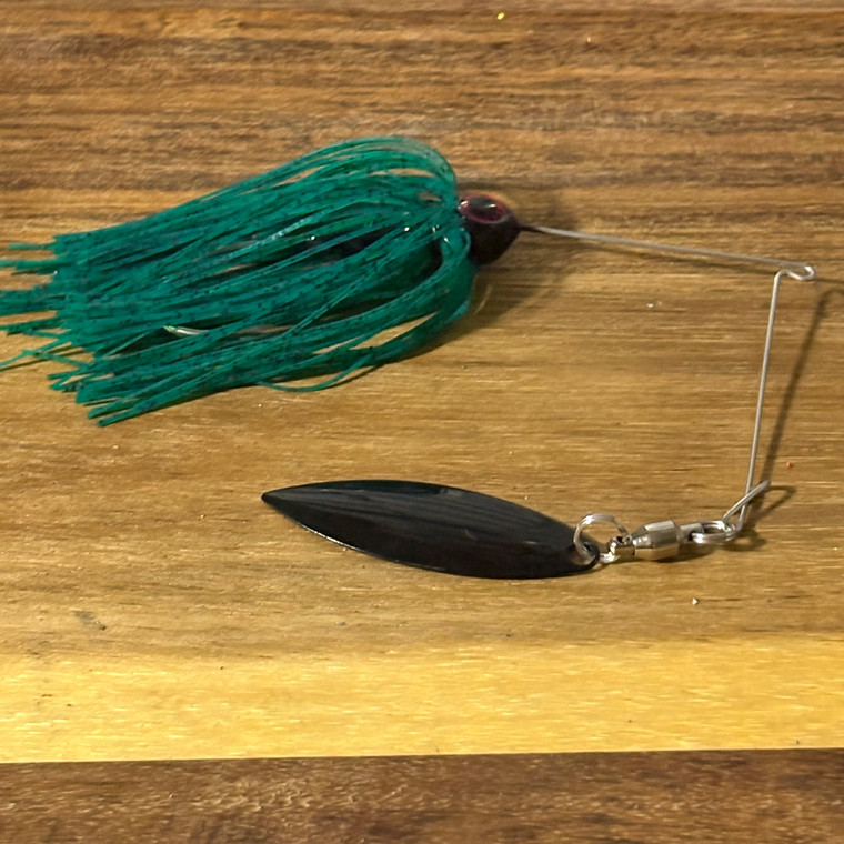 1/4 oz Blind Squirrel Baits spinnerbait. Black head, teal skirt, single black willow blade