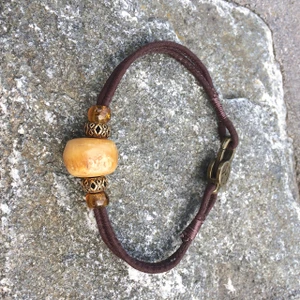 Peace Bracelet with Opaque Amber Focal, Fiber Cord, Glass and Metal Accents