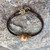 Peace Bracelet with Opaque Amber Focal, Fiber Cord, Glass and Metal Accents