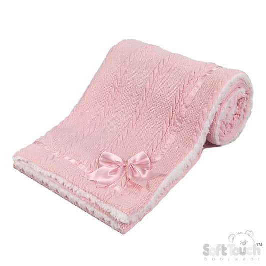 A soft and elegant PINK baby blanket featuring a textured knit design and a plush sherpa-style backing for extra warmth and comfort. Finished with a delicate satin bow, it’s perfect for keeping baby cozy at home or on the go.