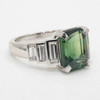 Emerald cut green sapphire with graduated baguette diamonds side view 