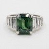 Emerald cut green sapphire with graduated baguette diamonds