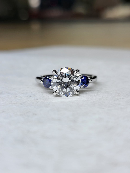 Brilliant Cut Diamond with Blue Sapphire Sides Ring 