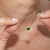 Oval Emerald Pendant with Diamond Halo on model holding