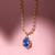 Blue Sapphire Pear Pendant on Ball Chain on pink valentine's heart