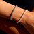 Rope Diamond Bracelet in Black Rhodium on wrist with rose gold bracelet