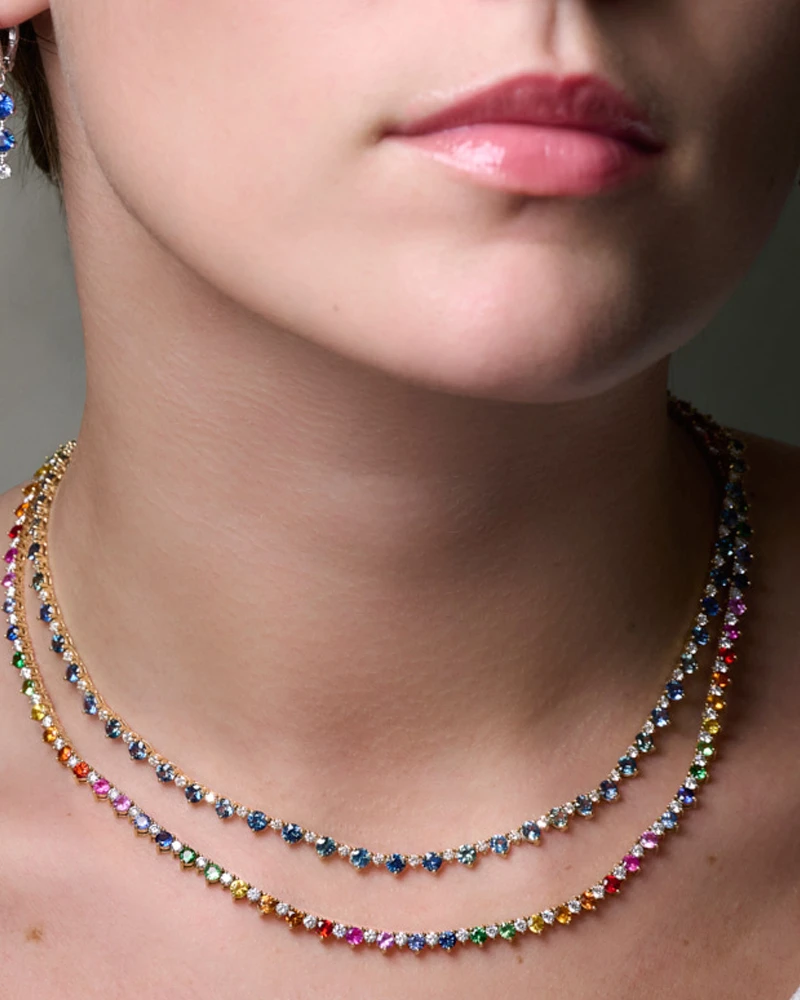 Multi-sapphire and diamond tennis necklaces and sapphire earrings on model 