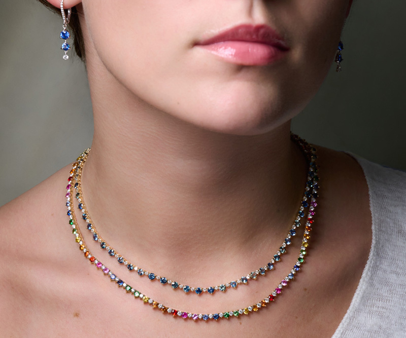 Multi-sapphire and diamond tennis necklaces and sapphire earrings on model 