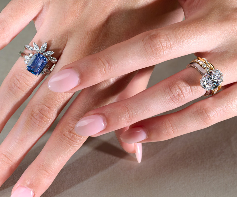 sapphire and diamond engagement rings with wedding bands on hand model 