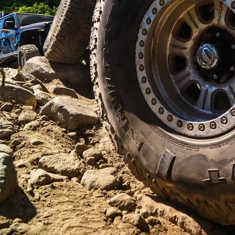 Off-road tire with sidewall damage on a rocky trail