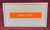 LMe-635 white on orange label tape for high-visibility labeling on bins, shelves, and files