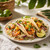 Shrimp tacos with grilled pineapple, cabbage slaw, lime, cilantro, and tropical seafood taco flavor.