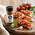 Tomato basil bruschetta on toasted bread with garlic, olive oil, fresh basil, and savory Italian seasoning for appetizers and snacks.