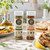 Grilling seasoning sampler kit with fresh lemons, herbs, olive oil, seafood, chicken, and vegetables for summer BBQ meals and outdoor cooking.