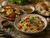 Italian pasta with grilled vegetables, bread, olive oil, basil, and savory seasoning