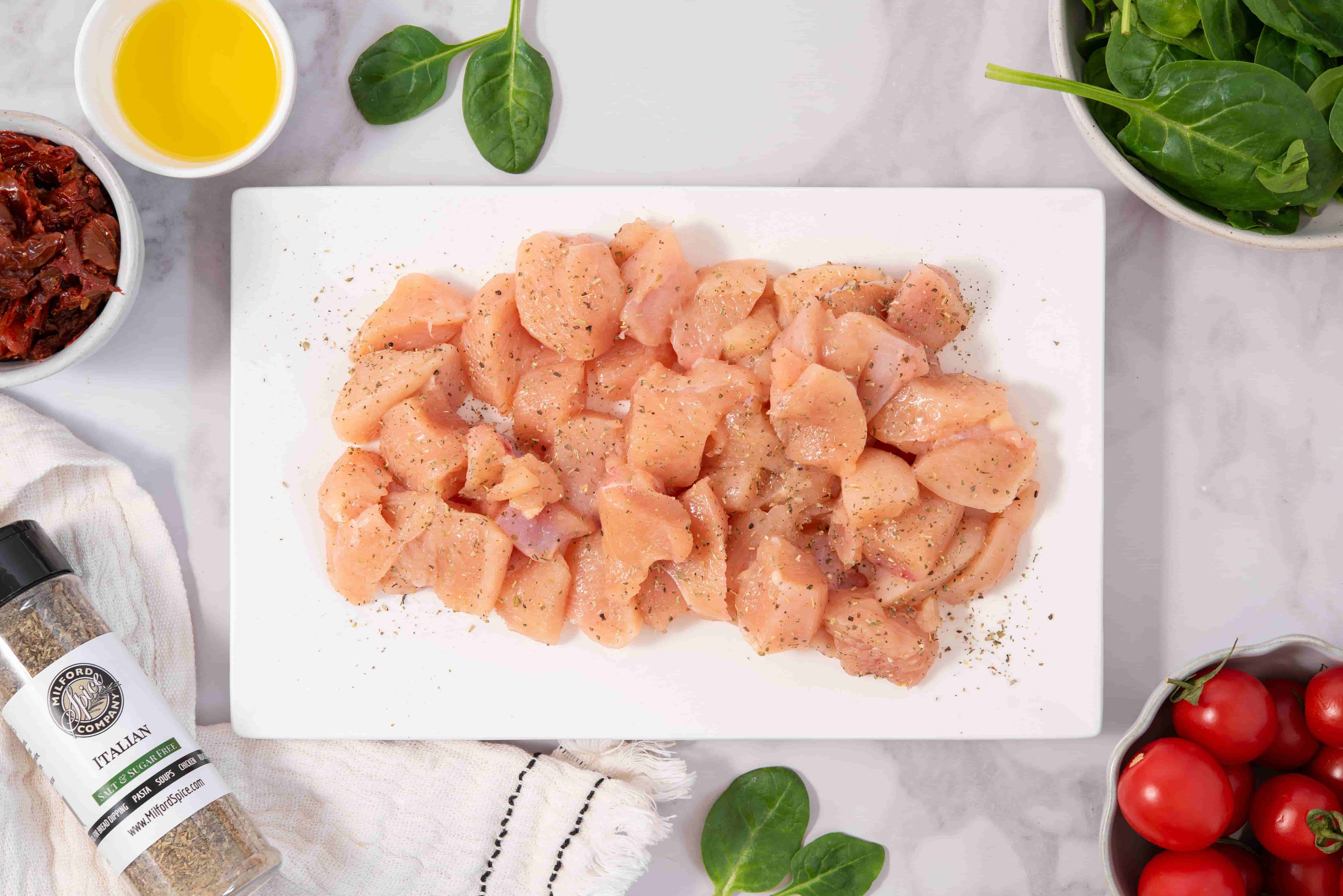 Bite-sized chicken pieces seasoned with Milford Spice Company Salt Free Italian Seasoning for creamy Marry Me Chicken Pasta