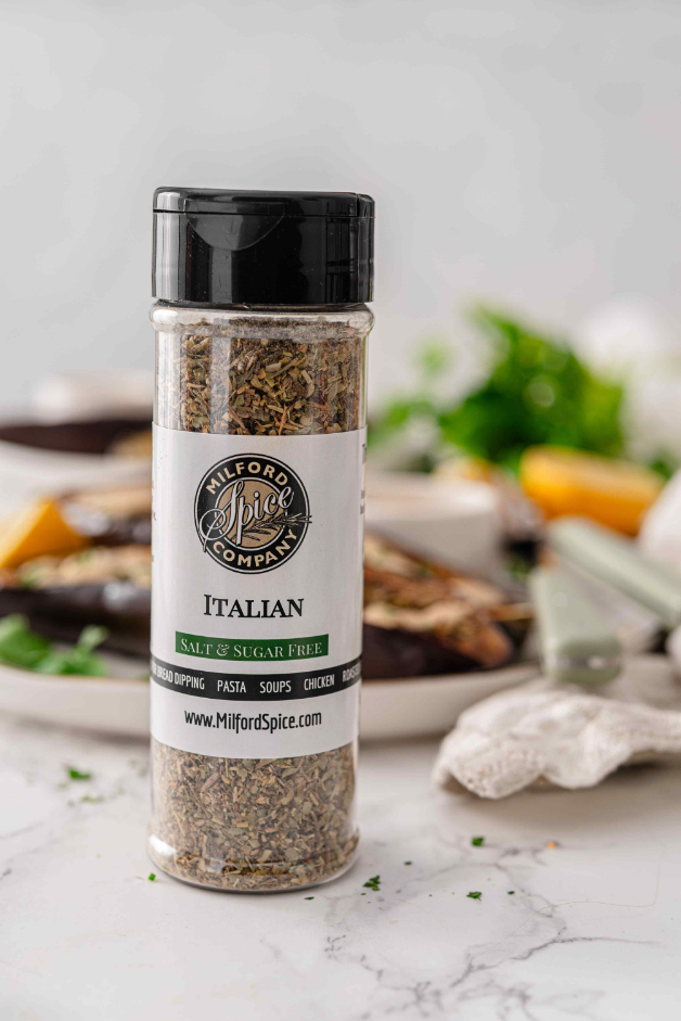 Milford Spice Company Salt Free Italian bottle with roasted eggplant and lemon tahini sauce in the background