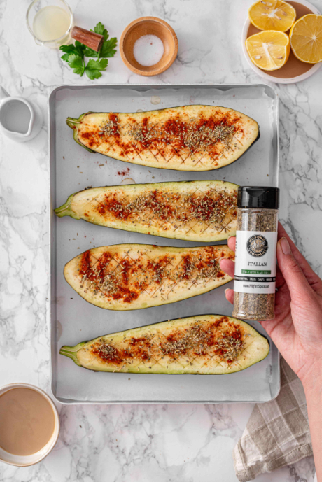 Milford Spice Company Salt Free Italian held over seasoned eggplant halves ready for roasting