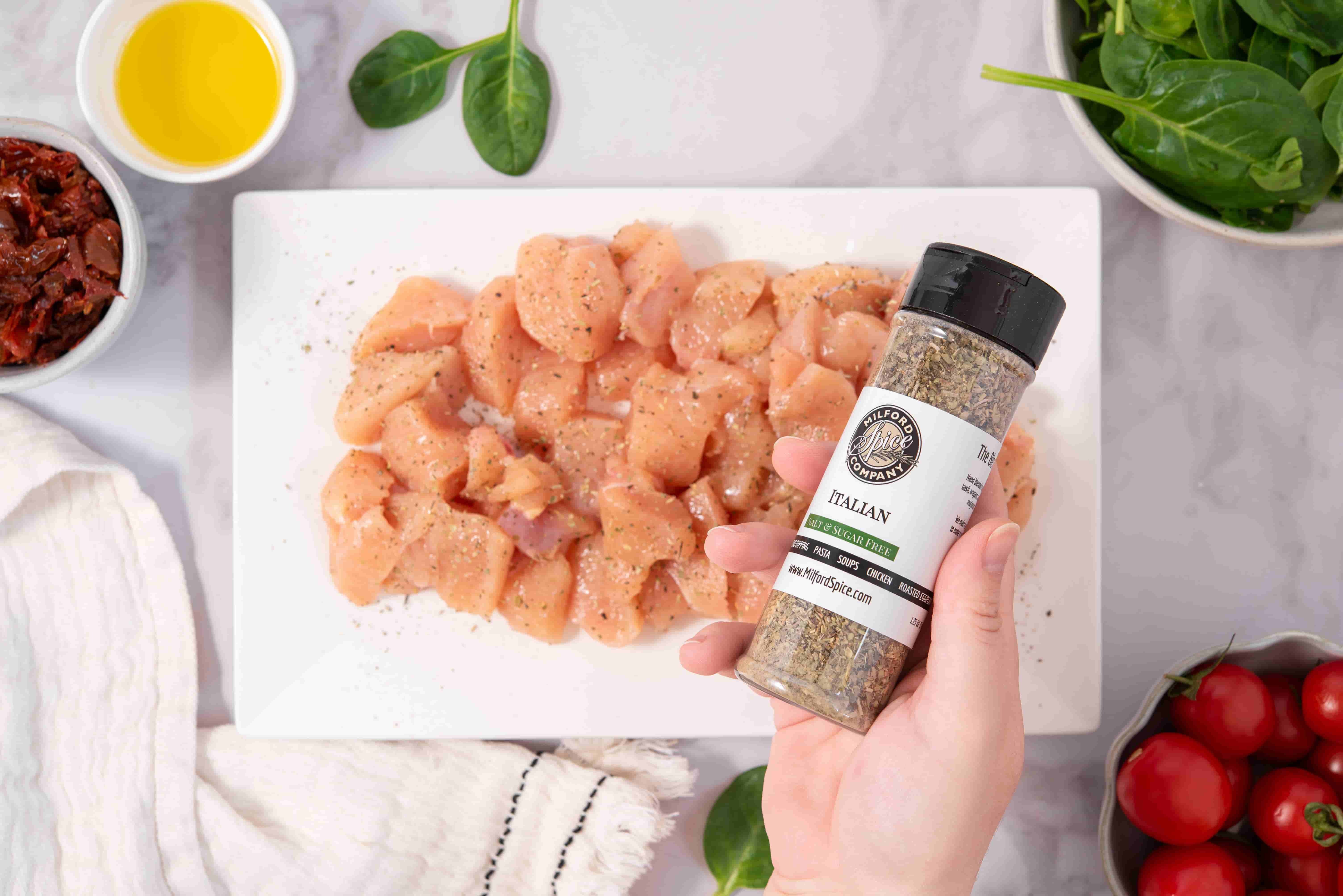 Milford Spice Company Salt Free Italian Seasoning held over seasoned chicken for Marry Me Chicken Pasta