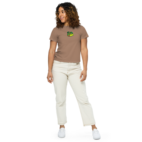 Woman wearing high-wasted pants and a light brown t-shirt featuring an original illustration of a crazed frog