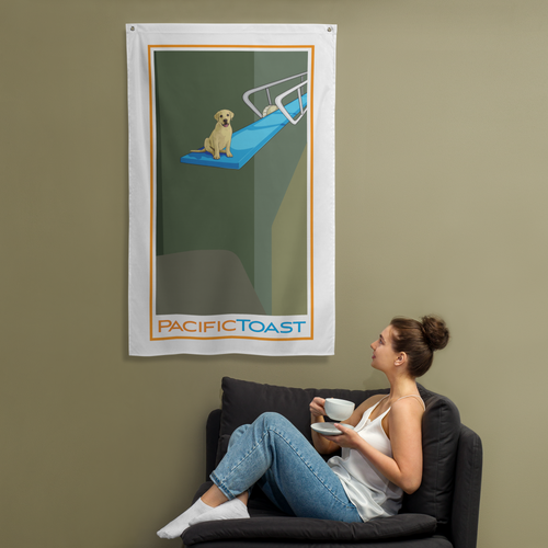 A sitting woman drinks coffee while admiring a wall banner illustrated with a cute, yellow Labrador puppy on a diving board